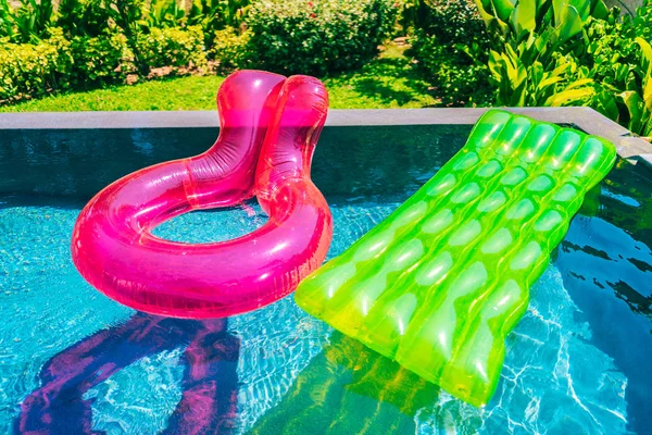 Colorful swim ring or rubber float around swimming pool water — Stock Photo, Image