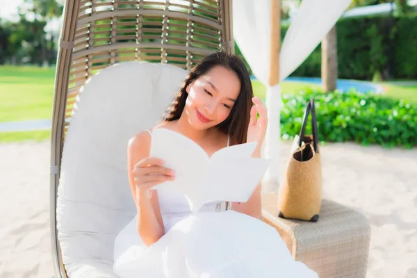 Portrait beautiful asian woman reading book around beach sea oce