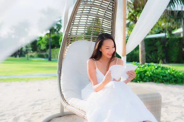 Портрет красива азіатська жінка читає книгу навколо пляжного моря океану — стокове фото