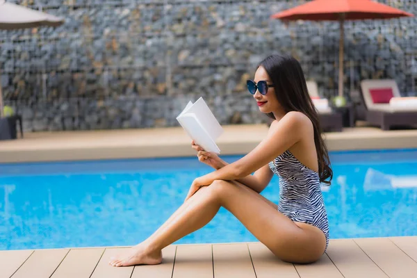 Portrait beautiful asian women read book around outdoor swimming