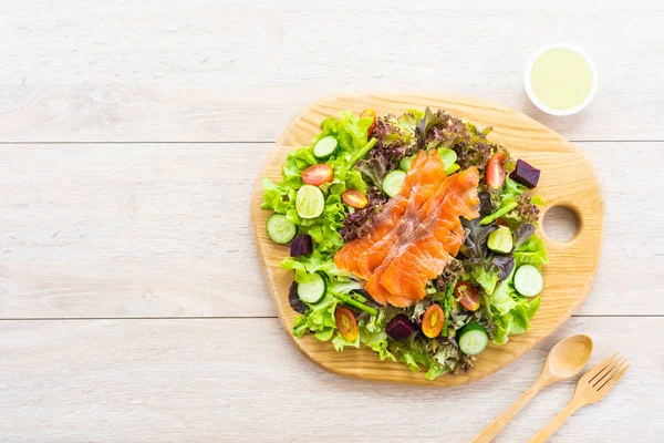 Raw Smoked salmon meat fish with fresh green vegetable salad