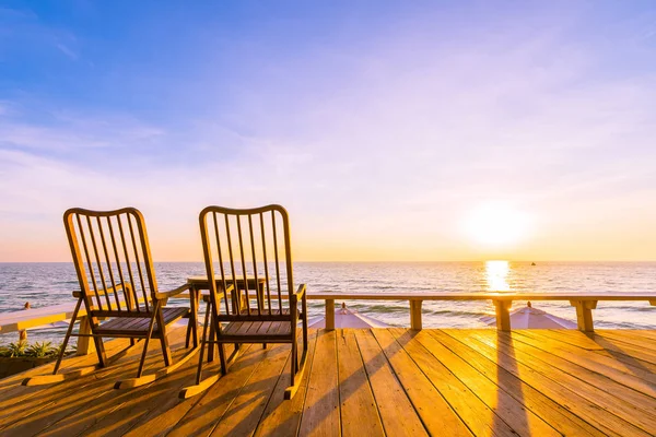 Empty wood chair and table at outdoor patio with beautiful tropi — Stock Photo, Image