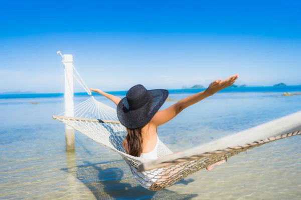 Portrait beautiful young asian woman sitting on hammock around s