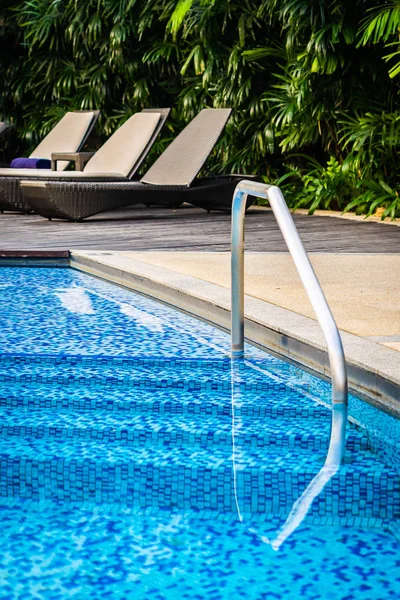 Belle piscine extérieure avec chaise longue et parasol — Photo
