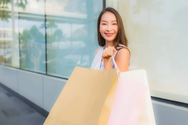 Porträtt vacker ung asiatisk kvinna lycklig och leende med shoppingga — Stockfoto