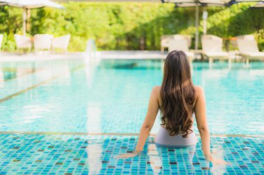 Portre güzel asya kadın mutlu gülümseme yüzme etrafında dinlenmek