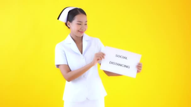 Footage Beautiful Asian Female Doctor Holding Paper Social Distancing Inscription — Stock Video