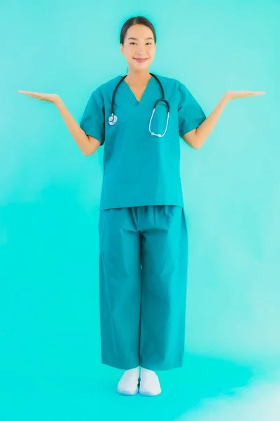 Portrait beautiful young asian doctor woman happy smile for work in hospital and clinic on blue isolated background