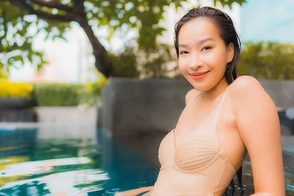 ポートレート美しい若いアジアの女性リゾートで屋外スイミングプールの周り幸せな笑顔のレジャーをリラックス — ストック写真
