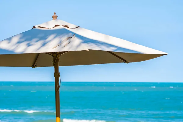 Umbrella and chair around beach sea ocean for travel vacation