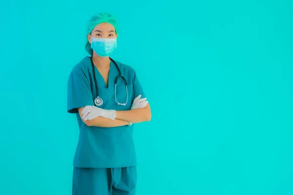 Portrait beautiful young asian doctor woman with mask and eyeglassses for protect from covid19 or coronavirus on blue isolated background