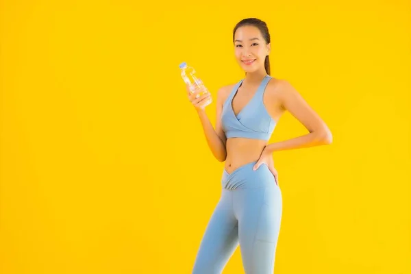 Portrait Beautiful Young Asian Woman Bottle Water Yellow Isolated Background — Stock Photo, Image