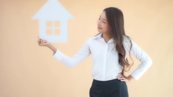 Beeldmateriaal Van Mooi Jong Aziatisch Zakenvrouw Met Huis Teken Geïsoleerd — Stockvideo