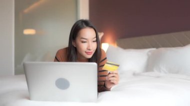 Evde dizüstü bilgisayarla çalışan Asyalı güzel bir kadının görüntüleri.