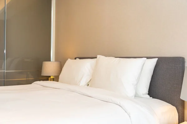 White pillow and blanket on bed decoration interior of bedroom interior with light lamp