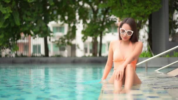 肖像画美しい若いアジアの女性幸せな笑顔休暇旅行のためのリゾートホテルで屋外スイミングプールをリラックス — ストック動画