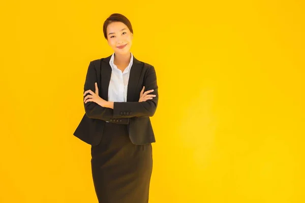 Beautiful portrait young business asian woman happy smile in many action on yellow isolated background