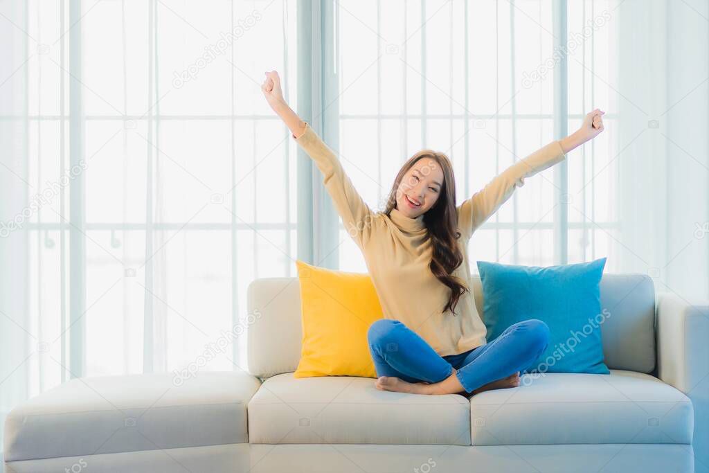 Portrait beautiful young asian woman relax leisure enjoy on sofa in living room interior area