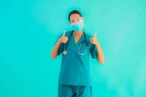 Portrait beautiful young asian doctor woman with mask and eyeglassses for protect from covid19 or coronavirus on blue isolated background