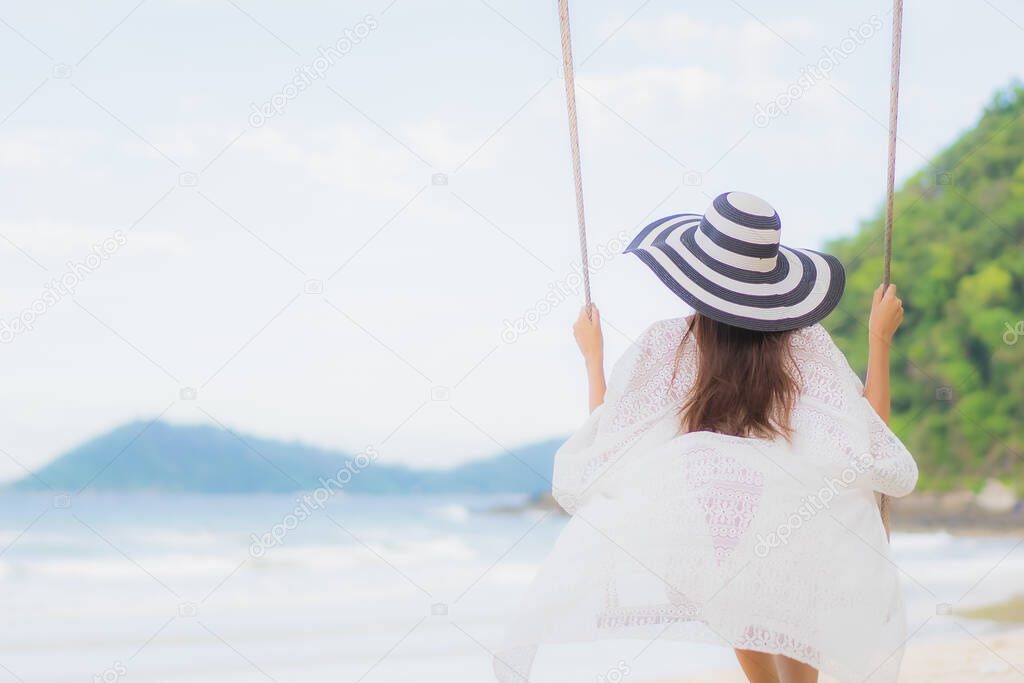 Portrait beautiful young asian woman relax smile around beach sea ocean in holiday vacation travel trip