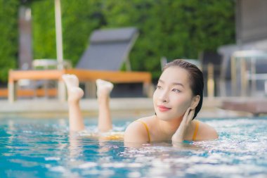 Güzel bir Asyalı kadın portresi. Rahatlayın. Tatil gezilerinde yüzme havuzunda rahatlayın.