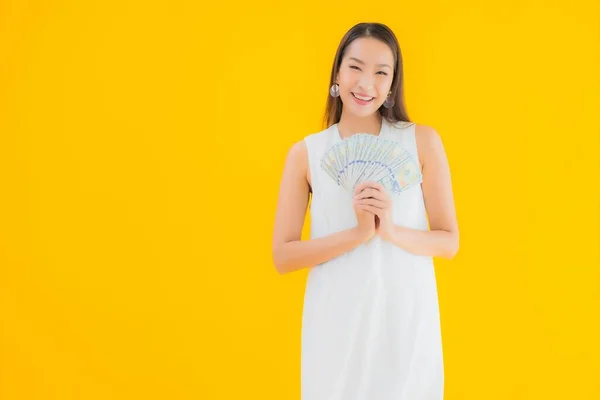 Portret Piękna Młoda Azjatycka Kobieta Pieniędzmi Gotówką Żółtym Odizolowanym Tle — Zdjęcie stockowe