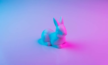 Renkli ultraviyole holografik neon ışıkları ile beyaz Paskalya tavşanı. Yaratıcı kavramı.