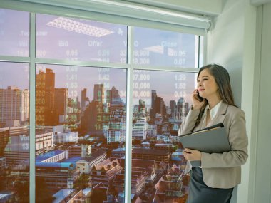 Modern iş kadınları hakkında borsa ofisinde, cityscape stok numarası, iş concep ile pencereden dışarı bakarak beyaz mobilephone konuşmak kullanın