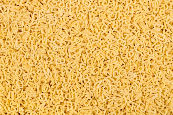 Textura del alfabeto crudo abc letra fideos pasta comida italiana ma — Foto de Stock