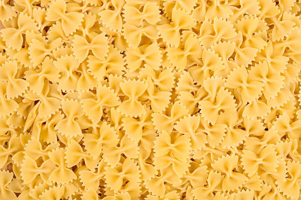 Texture of raw farfalle noodles pasta italian food macro backgro — Stock Photo, Image