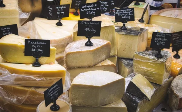 A variety of cheese for sale at the deli counter in a supermarket