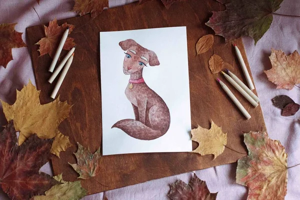 Drawing on the background of autumn decor and autumn leaves. Autumn home decor.