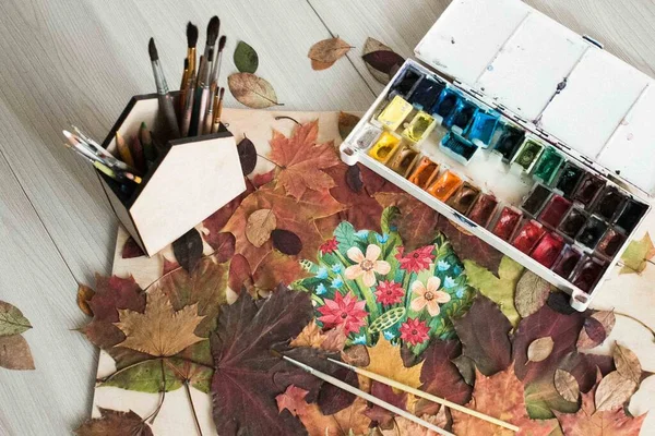 Drawing on the background of autumn decor and autumn leaves. Autumn home decor.