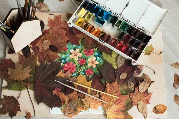 Drawing on the background of autumn decor and autumn leaves. Autumn home decor.