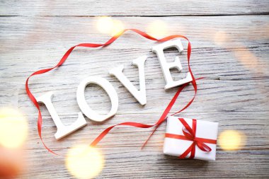 kırmızı yay ve kalpleri altın bokeh, Sevgililer günü hediyesi, seni seviyorum etiketi Beyaz ahşap zemin üzerine beyaz hediye kutusu