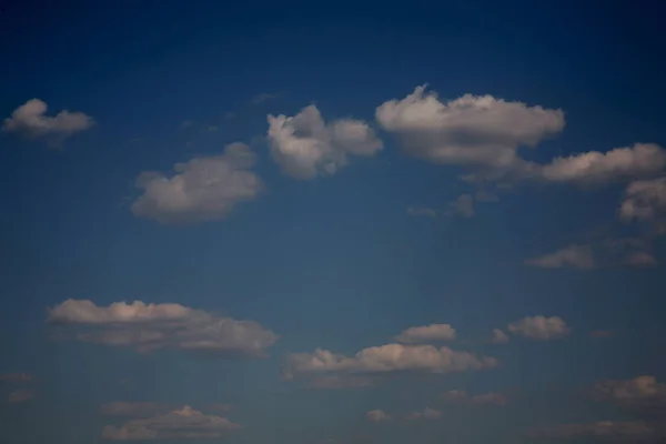 The clusters of broken clouds are scattered across the sky