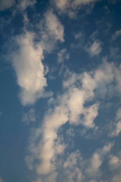 A perfectly clear blue sky shrouded in a veil of beautiful clouds