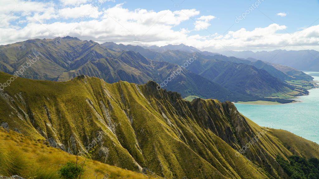 Dramatic features of Southern Alps with blue lake in the background, New Zealand
