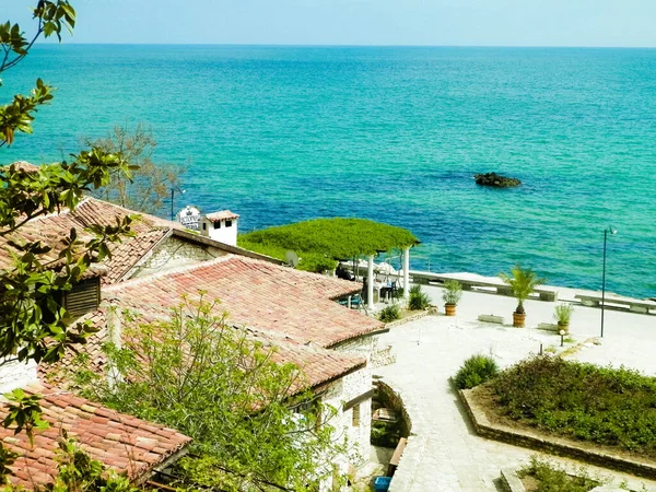 Black sea water and houses in coastal area of Balchik city, Bulgaria. Tourism concept.