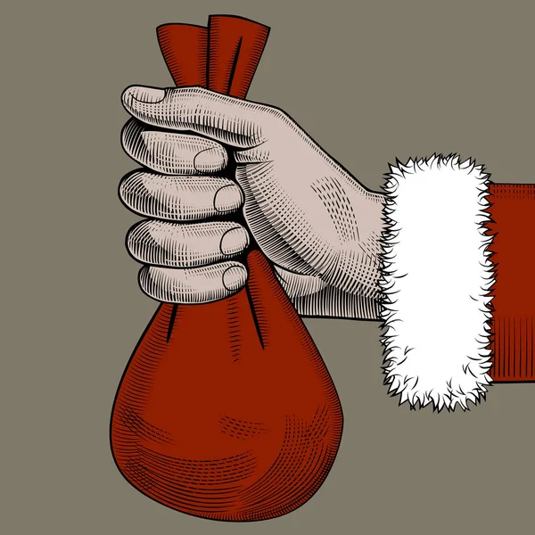 Mano de Santa Claus sosteniendo un saco rojo pequeño — Vector de stock