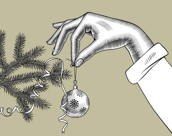 Mano femenina colgando una bola de árbol de Navidad en una rama de abeto ingenio — Archivo Imágenes Vectoriales