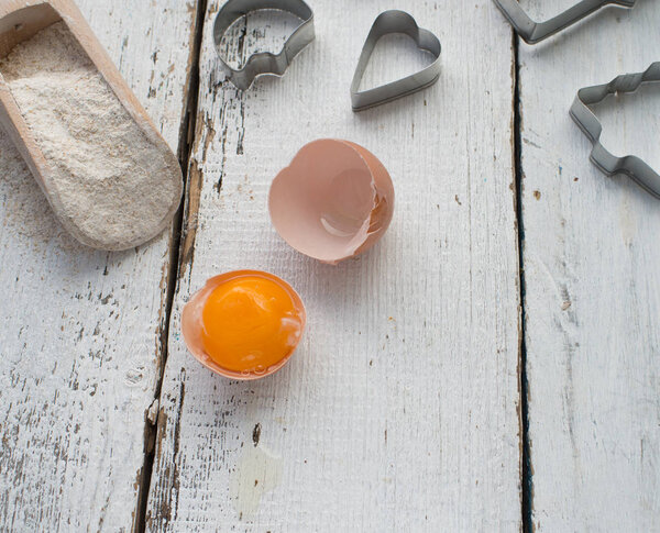 cookies cutters  and egg on background,close up