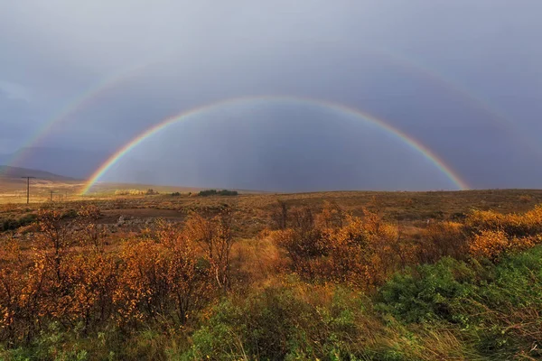 A double rainbow over a field on the Golden Circle in Iceland during autumn