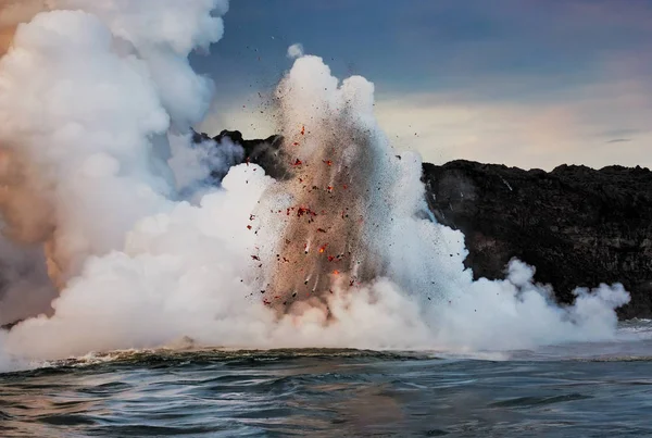 Stock image A small taste of the Fury of Mother Nature. Hot lava gushes out from lava tubes into the ocean and, when coinciding with incoming waves, creates spectacular mini explosions such as these.