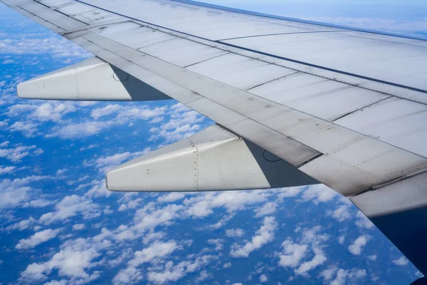 白い雲と航空機の翼の部分的な閉鎖と高高度の青い空 — ストック写真