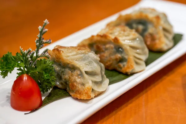 A Cantonese morning tea dim sum, fried dumplings, leek dumplings