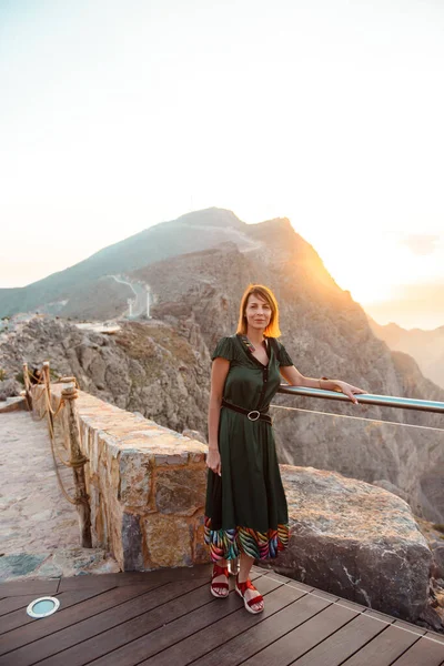 Woman in the mountains Emirate at sunset