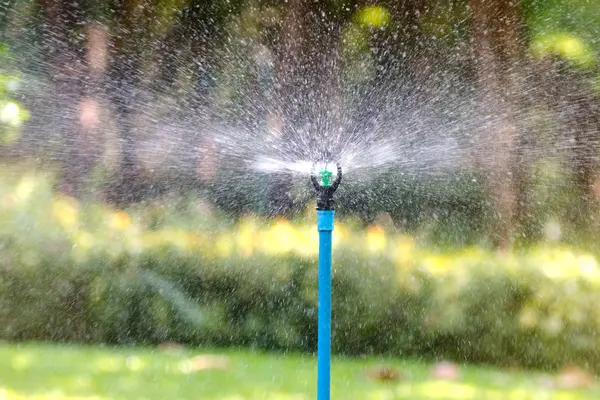 Water sprinkler system working in garden