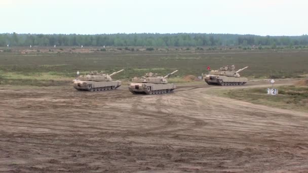 Abrams Tank Reversing Other Tanks Large Open Field — Stock Video