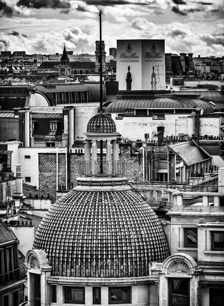 Black and white photo of Paris buildings. Beautiful panorama view from famous Printemps store in France. Panoramic view from rooftop.